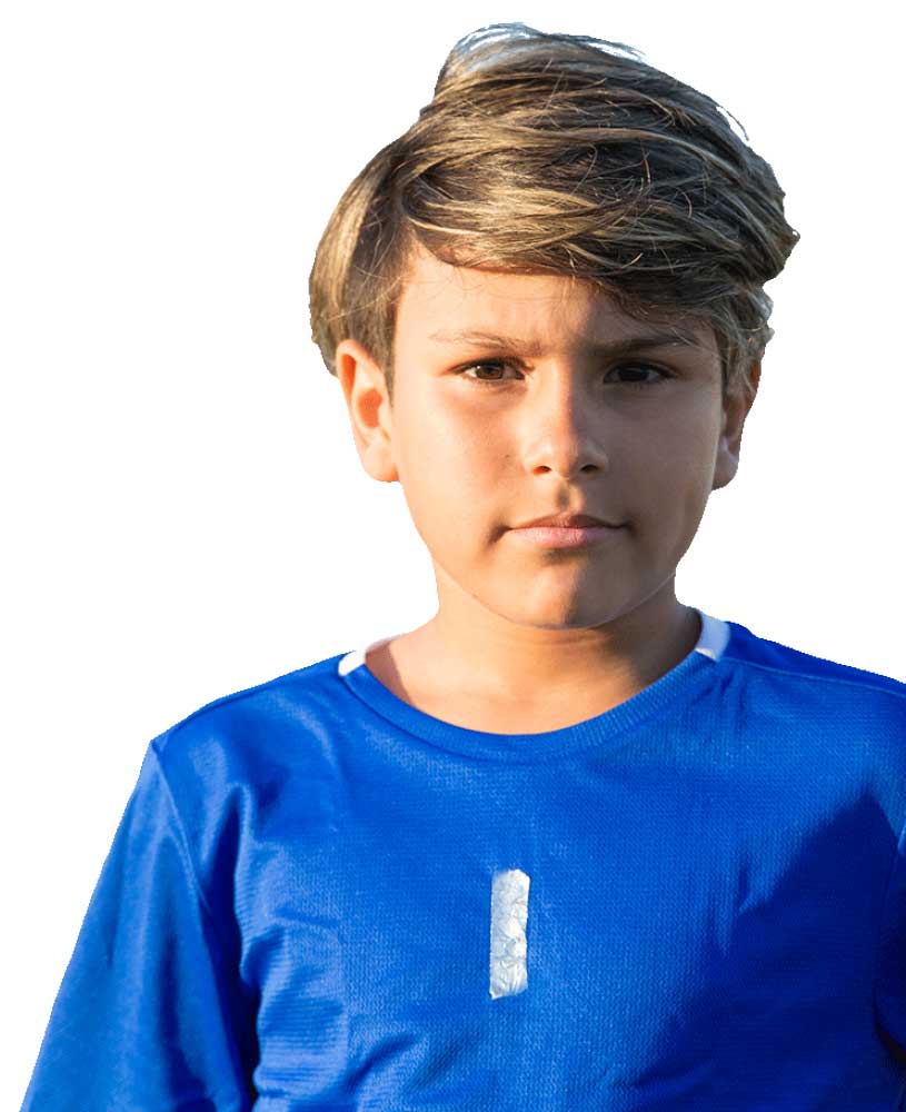 A young footballer wearing a blue football shirt