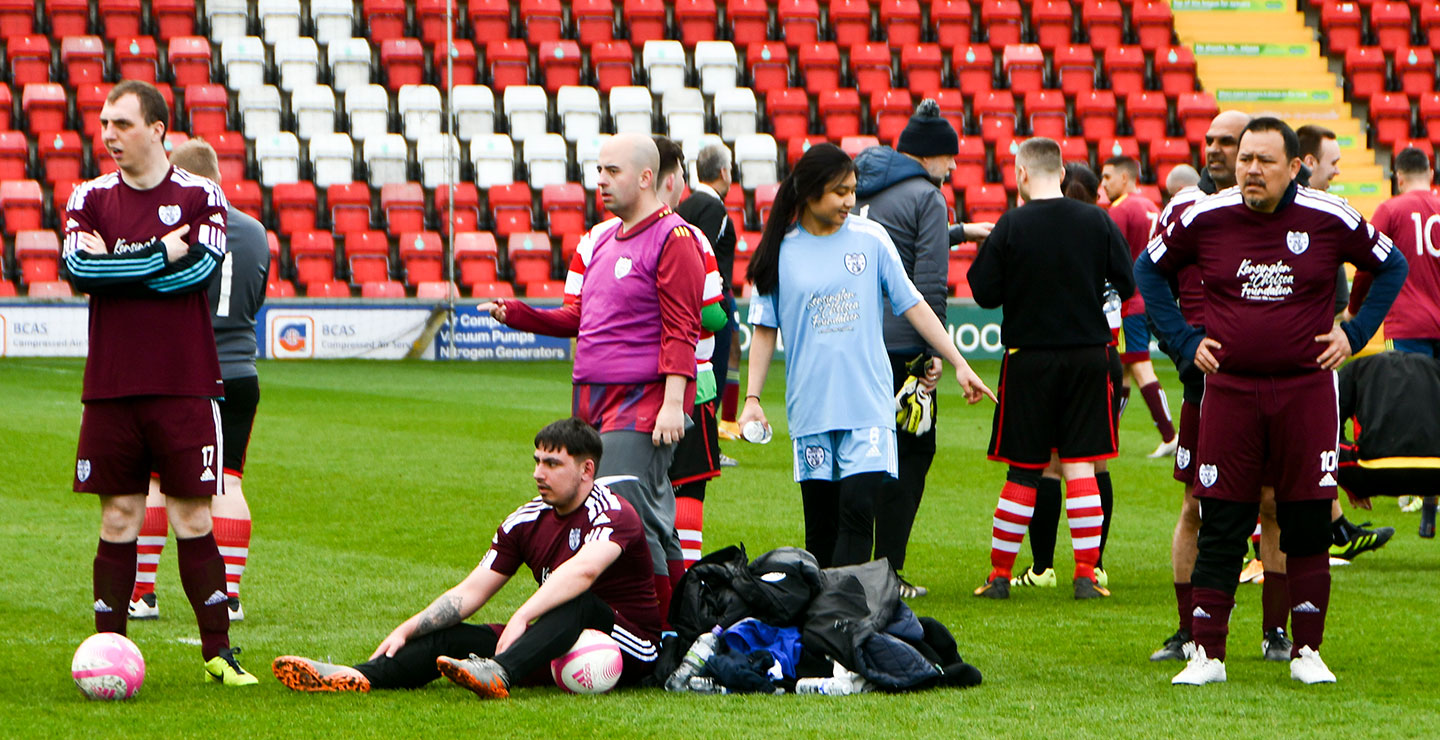 Adult players waiting to play in a tournament held at Woking FC's Laithwaite Stadium
