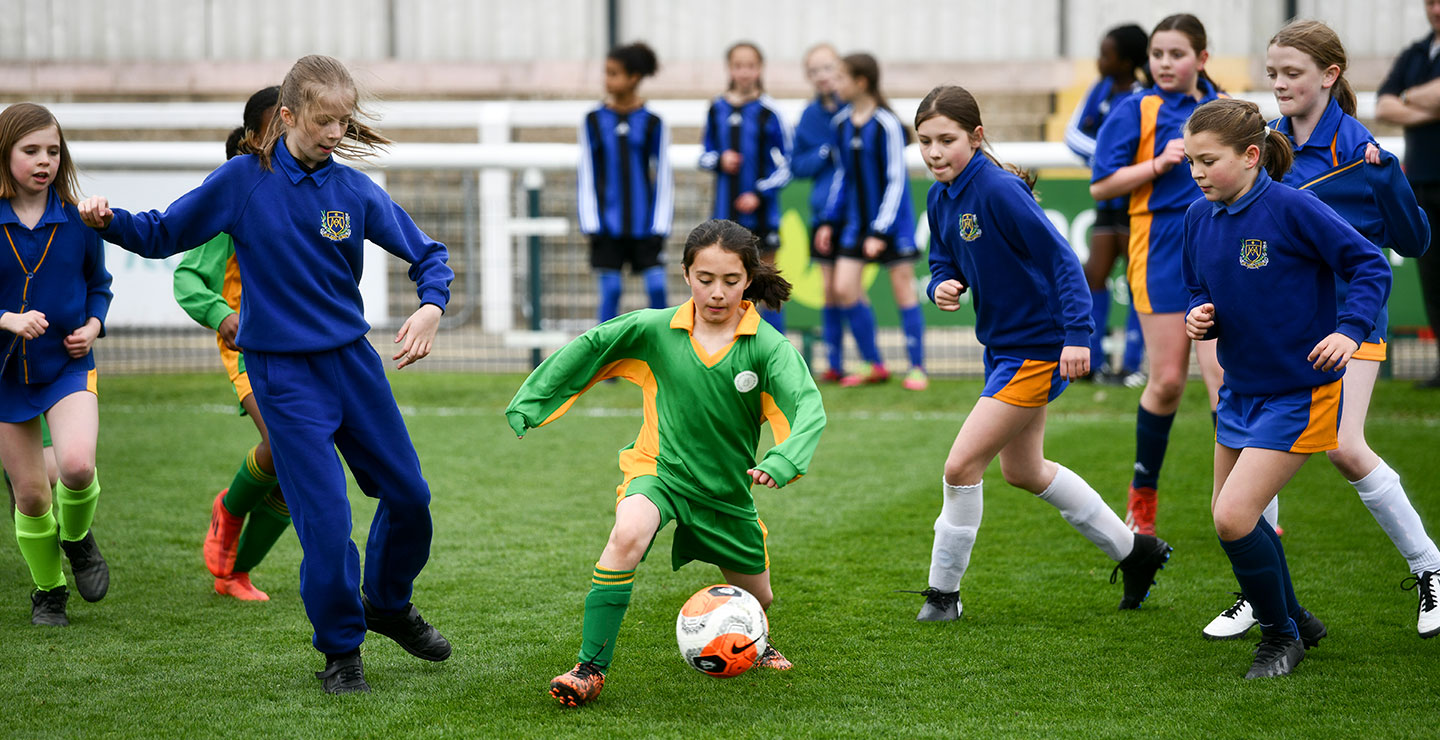 Girls playing in a youth football tournament