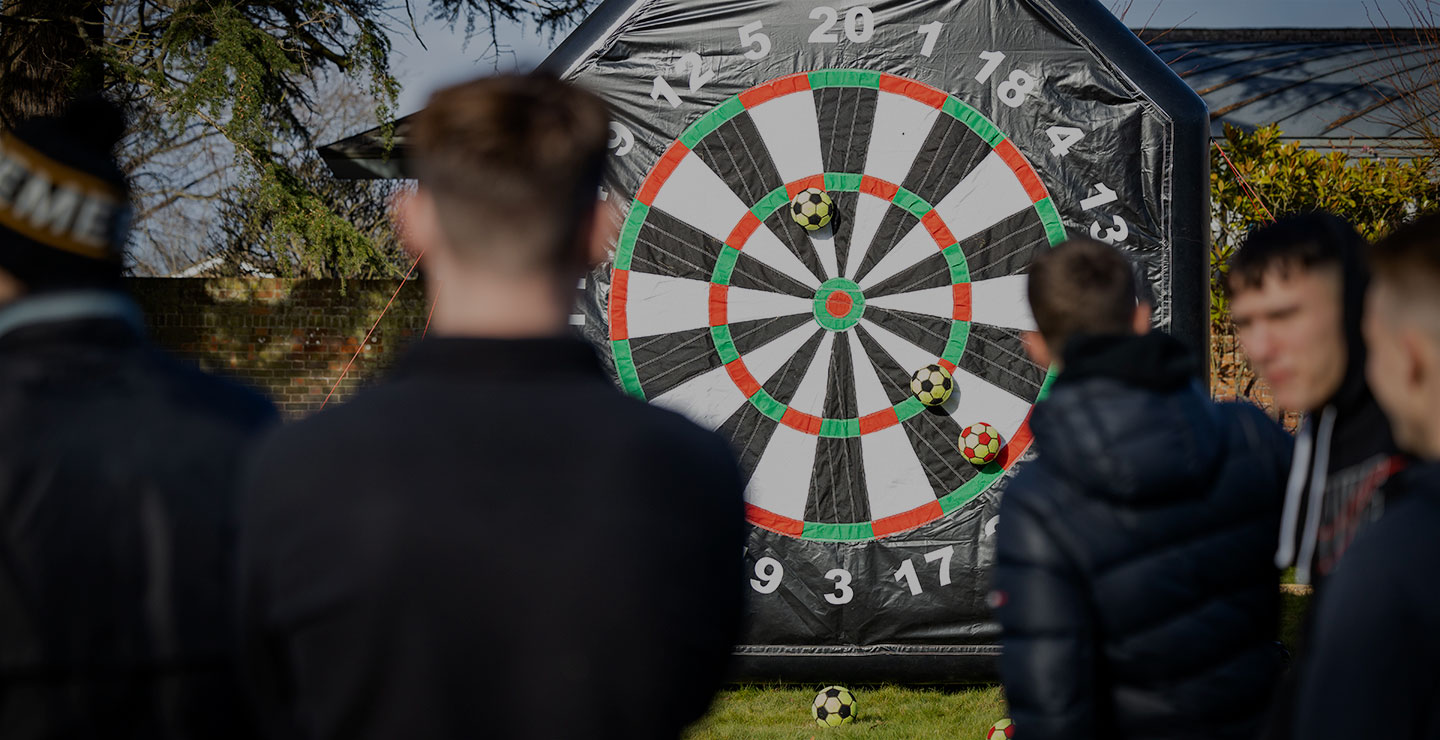 Woking FC Academy team building activity featuring a giant dartboard used for shooting practice